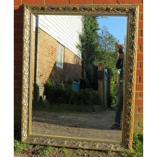 872 - A large rectangular gilt framed bevelled wall mirror with moulded surround in the Art Nouveau taste.... 