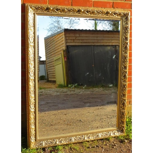 872 - A large rectangular gilt framed bevelled wall mirror with moulded surround in the Art Nouveau taste.... 