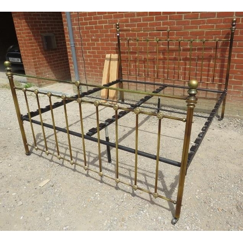 873 - An antique style brass kingsize bed with ball finials and cast roundel detail to head and footboards... 