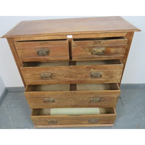 874 - An Edwardian limed oak chest of two short over three long graduated drawers, with pressed brass Art ... 