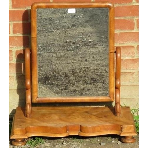 875 - A large Victorian walnut swing vanity mirror, on a shaped-front plinth base with bun feet. 
Conditio... 