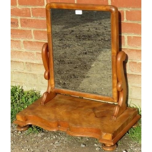 875 - A large Victorian walnut swing vanity mirror, on a shaped-front plinth base with bun feet. 
Conditio... 