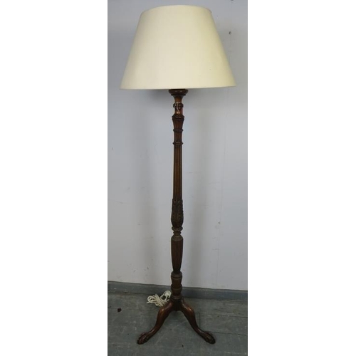 885 - A vintage mahogany standard lamp, with carved and fluted column in the Regency taste, on a tripod ba... 