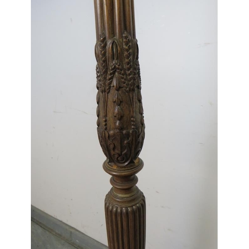 885 - A vintage mahogany standard lamp, with carved and fluted column in the Regency taste, on a tripod ba... 