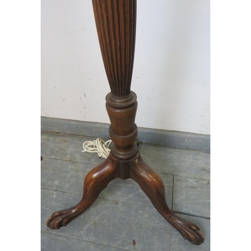 885 - A vintage mahogany standard lamp, with carved and fluted column in the Regency taste, on a tripod ba... 