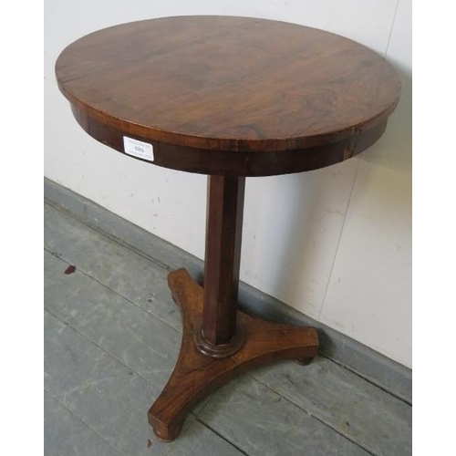 886 - A Regency rosewood pedestal wine table, on a tapering octagonal column terminating on a triform base... 