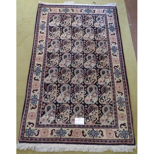 901 - A late 20th century wool rug with a repeat pattern to central field, blue/cream. 200cm x 121cm. Very... 