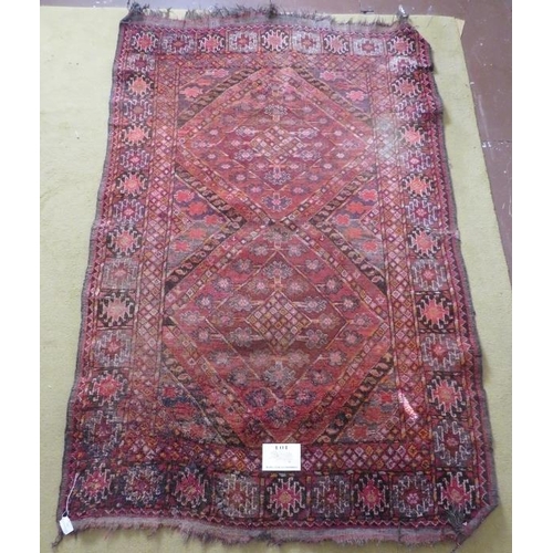 903 - An early 20th century Persian rug, pale red - pink field , some wear conducive to age. 186cm x 117cm... 