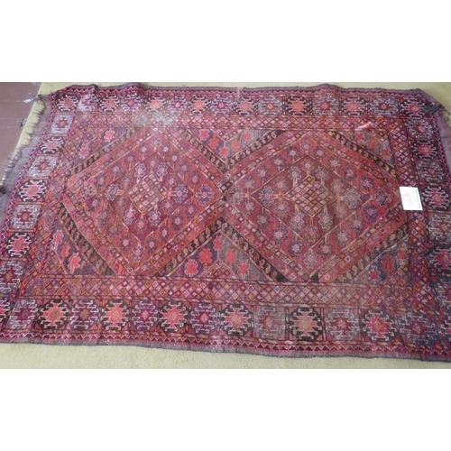 903 - An early 20th century Persian rug, pale red - pink field , some wear conducive to age. 186cm x 117cm... 