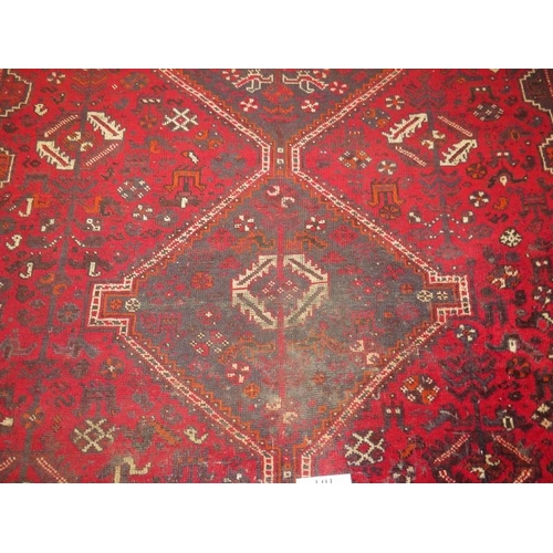 905 - A mid 20th century Persian carpet. 3 repeat central motifs with stylised birds on a claret field. So... 