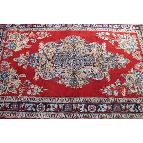 908 - Central Persian Qum rug. Pastel shades of floral, pattern on red ground. Good condition. 170cm x 108... 