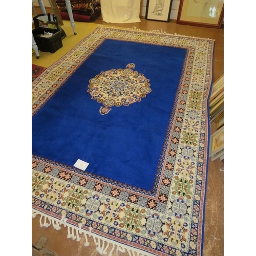 911 - A Moroccan late 20th century wool carpet, central cream motif on a deep blue ground and cream patter... 