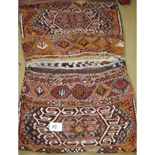 922 - A large late 19th-early 20th century Persian saddle bag (very nice), a small Persian rug and a long ... 