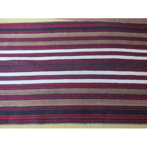 925 - A mid - late 20th century Afghan rug/runner, red/brown, black and white stripe. 310cm x 94cm.
Condit... 