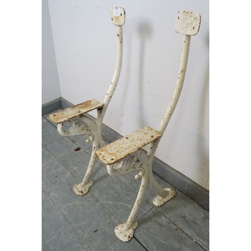 878 - A pair of antique cast iron bench ends painted white, featuring acanthus leaf decoration. 
Condition... 