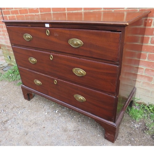 866 - A George III mahogany straight front chest of three long graduated oak-lined drawers with pressed gi... 