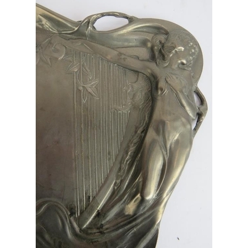 239 - A cast pewter Art Nouveau style dish with girl and harp design. 23cm x 22cm.
Condition report: No is... 