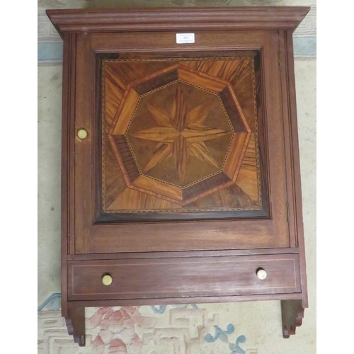 707 - A vintage wall hanging cabinet, the panelled door featuring starburst parquetry inlay with one long ... 