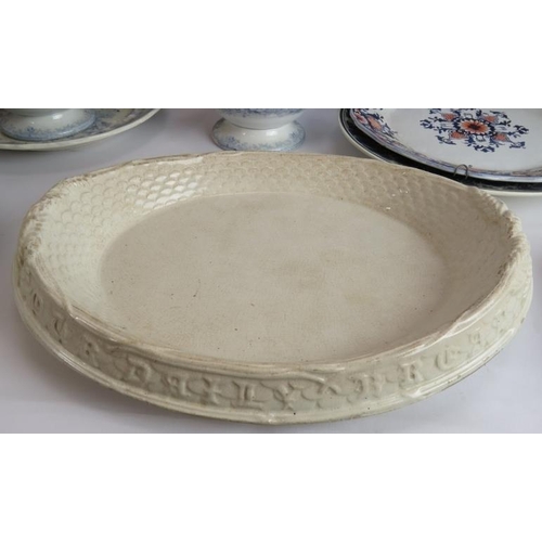 115 - A mix of mainly ceramic kitchen and table ware including plates, platters, tureens, bread plate and ... 