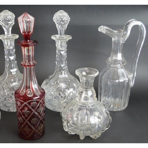 118 - Four antique cut glass decanters, a similar claret jug, an early 19th century carafe and a ruby cut ... 