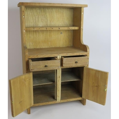 125 - A miniature vintage stripped pine Welsh dresser with two drawers and cupboard. Height: 63cm, width: ... 