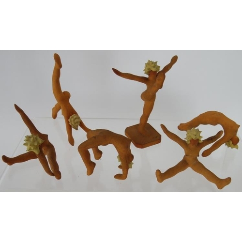 137 - A set of nine miniature Art Deco terracotta female gymnast figures in various poses, two marked R.E.... 