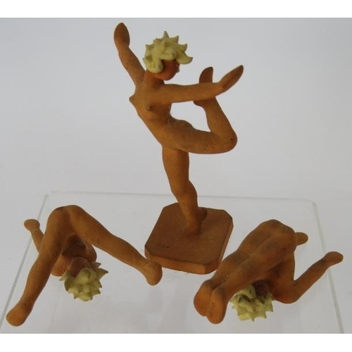 137 - A set of nine miniature Art Deco terracotta female gymnast figures in various poses, two marked R.E.... 