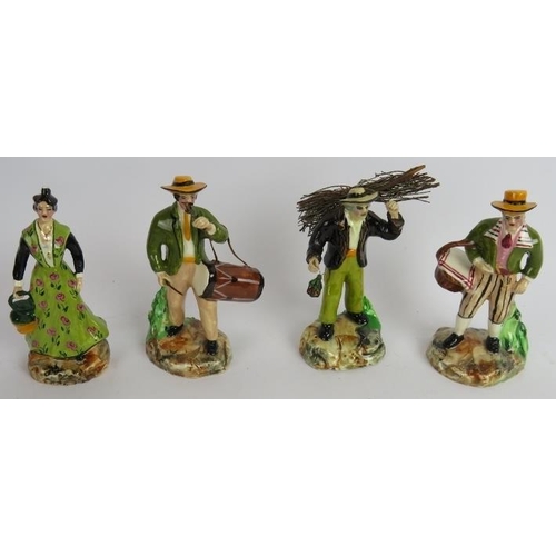 153 - A collection of small hand painted continental pottery figures portraying country peasants. Tallest:... 