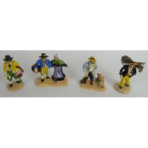 153 - A collection of small hand painted continental pottery figures portraying country peasants. Tallest:... 