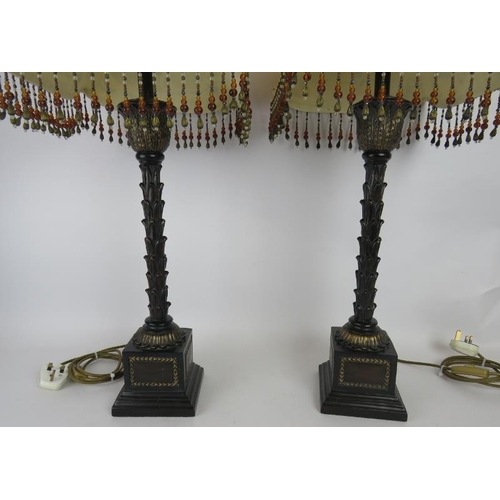 166 - A pair of palm leaf column table lamps with bronzed finish an ornate beaded shades. Overall height 7... 