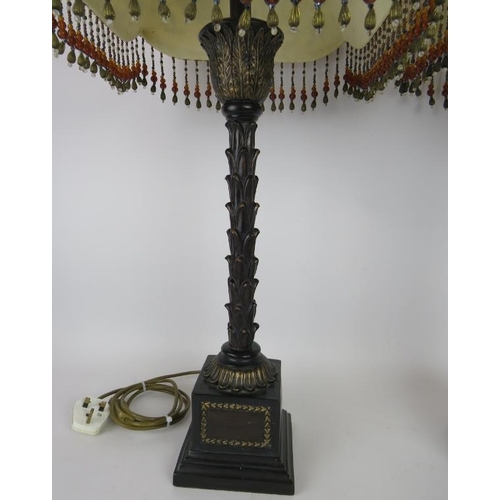 166 - A pair of palm leaf column table lamps with bronzed finish an ornate beaded shades. Overall height 7... 