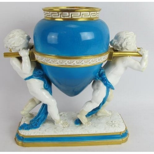 195 - A 19th century Mintons porcelain vase in the form of two putti carrying an urn. White and turquoise ... 