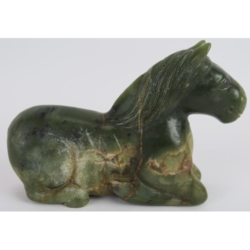 206 - A Chinese carved spinach Jade recumbent horse, Ming style but likely Qing, 16cm long x 10cm high.
Pr... 