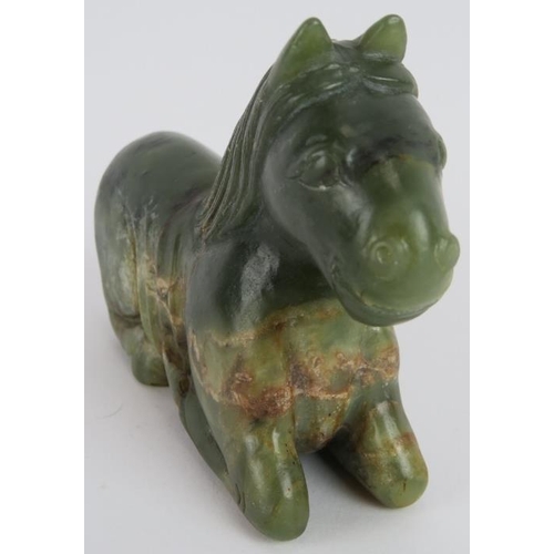 206 - A Chinese carved spinach Jade recumbent horse, Ming style but likely Qing, 16cm long x 10cm high.
Pr... 