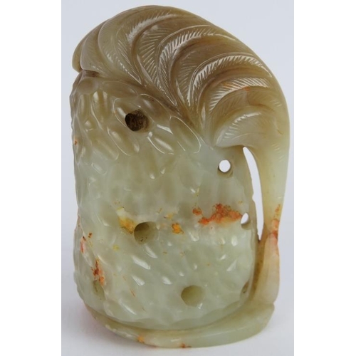 207 - A Chinese carved pale green and russet Jade boulder, depicting an animal standing beside foliage, Mi... 