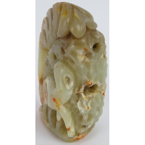 207 - A Chinese carved pale green and russet Jade boulder, depicting an animal standing beside foliage, Mi... 