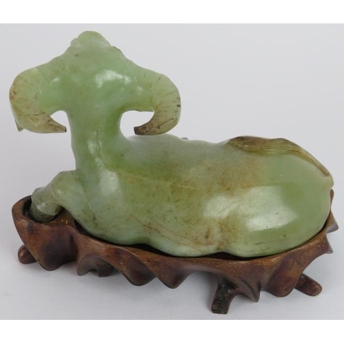 208 - A Chinese carved celadon Jade recumbent water Buffalo, Ming style but likely Qing, resting on a besp... 