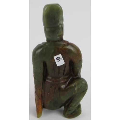 215 - A Chinese carved dark spinach Jade crouching Sage, holding his beard in a ponderous pose, with russe... 