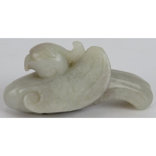 216 - A Chinese carved pale celadon Jade Phoenix, Ming style but likely Qing, 8cm long x 4cm high.
Provena... 