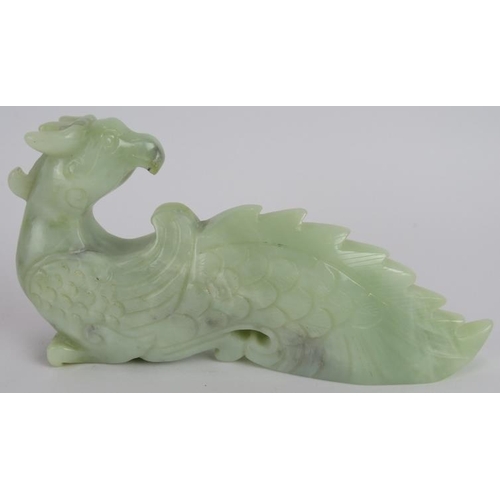 218 - A Chinese carved pale celadon Phoenix, Ming style but likely Qing, 16cm long x 8cm high.
Provenance:... 