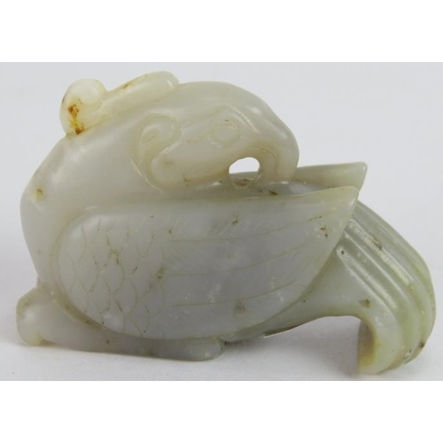 219 - A Chinese carved celadon, pale celadon and russet Jade Phoenix, Ming style but likely Qing, 6cm long... 