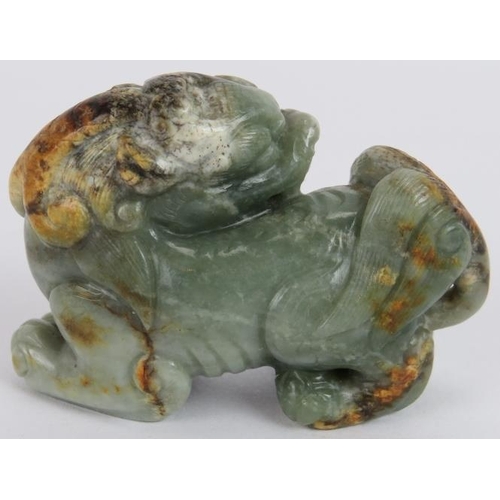 222 - A Chinese carved celadon and russet Jade Dog of Fo, Ming style but likely Qing, 7cm long x 5cm high.... 