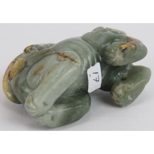 222 - A Chinese carved celadon and russet Jade Dog of Fo, Ming style but likely Qing, 7cm long x 5cm high.... 