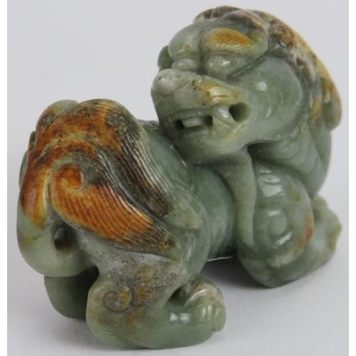 222 - A Chinese carved celadon and russet Jade Dog of Fo, Ming style but likely Qing, 7cm long x 5cm high.... 