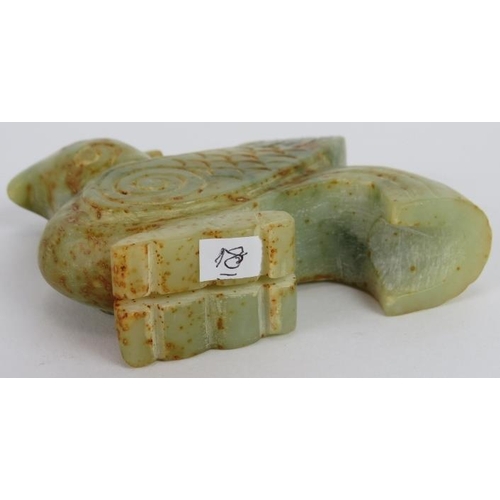 223 - A Chinese carved celadon and russet Jade Phoenix, Ming style but likely Qing, 8cm high x 9cm long.
P... 