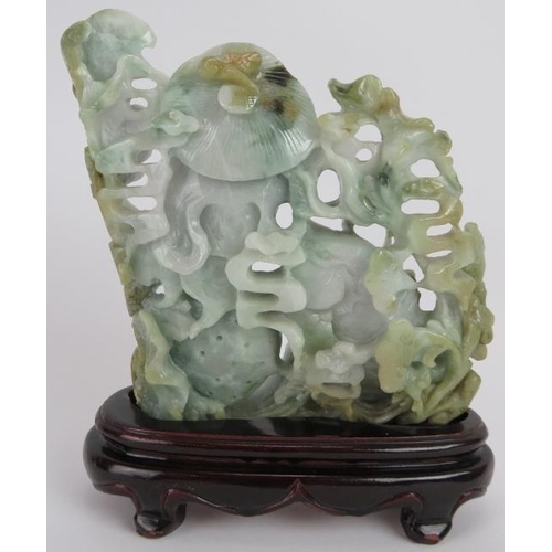 227 - An intricate Chinese carved celadon Jade group of a fisherman catching fish, with russet and black i... 