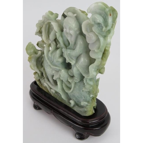 227 - An intricate Chinese carved celadon Jade group of a fisherman catching fish, with russet and black i... 