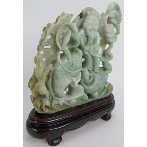 227 - An intricate Chinese carved celadon Jade group of a fisherman catching fish, with russet and black i... 