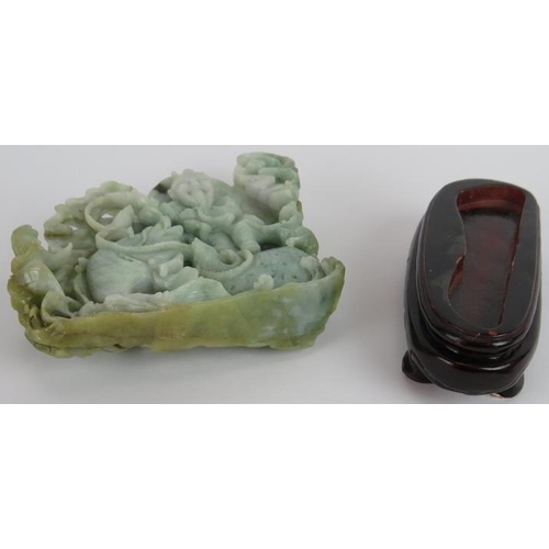 227 - An intricate Chinese carved celadon Jade group of a fisherman catching fish, with russet and black i... 