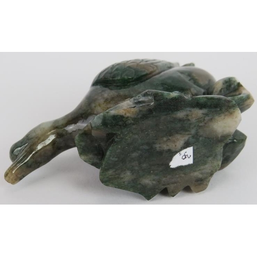 235 - A Chinese carved Mottled spinach Jade duck on a naturalist base, Ming style but likely 20th century,... 